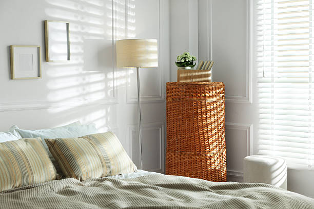 istock Wicker storage basket, bed and lamp indoors 2246665444