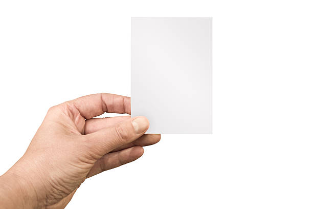 istock Hand holding a blank white vertical note or business card isolated on white background, cut out 2246668170