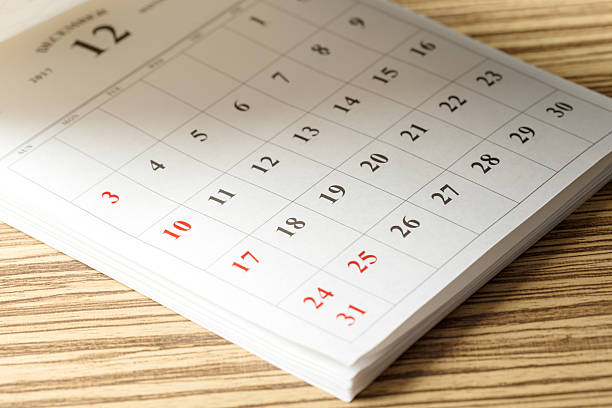 istock December calendar page showing dates and layout on wooden table 2246669877