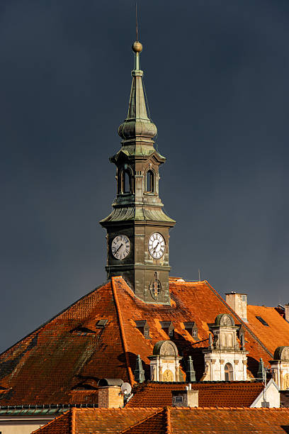 istock Dark sky with rain clouds over the historic city with a tower clock. 2246669904