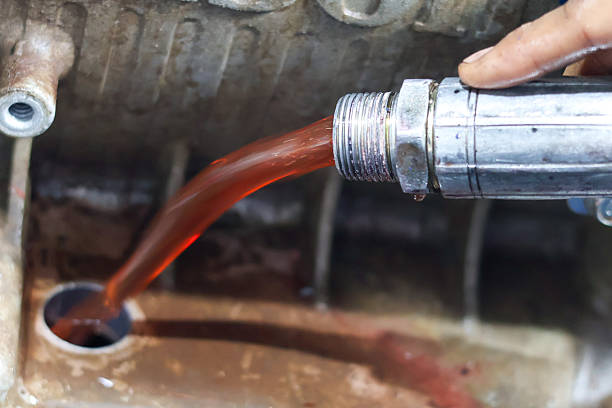 istock A mechanic is pouring bright red transmission fluid 2246671381