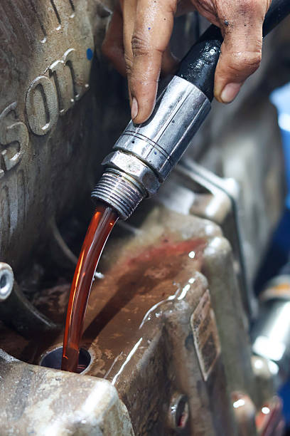 istock A mechanic is pouring bright red transmission fluid 2246671400