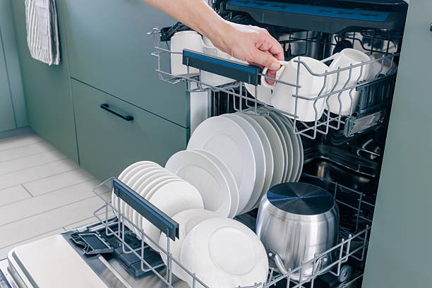 istock Dishwasher. Woman unloading dishwasher with clean utensils. In dishwasher machine with clean dishes. 2246674436