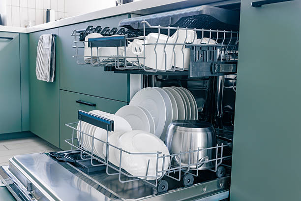 istock Open the dishwasher with clean white dishes after washing in a modern kitchen. 2246674499