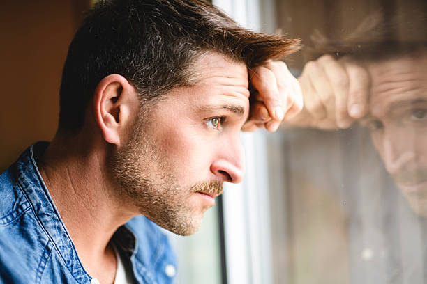 istock relaxed man having emotional time close to a window 2246677153