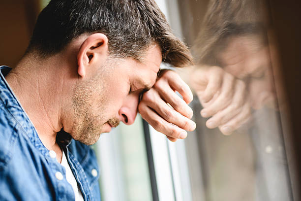 istock relaxed man having emotional time close to a window 2246677163