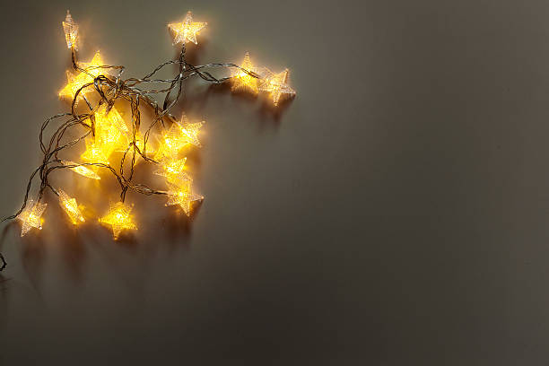 istock Twinkling star lights create a warm glow on a simple background at night 2246679887