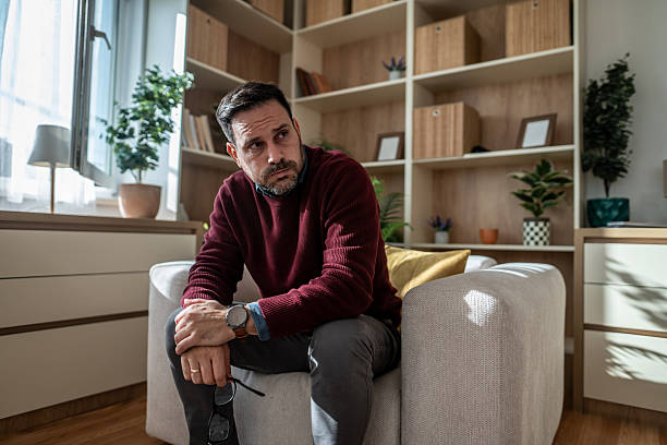 istock Worried man thinking about mental health problems at home 2246680732