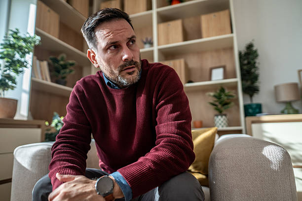 istock Mature man sitting at home having worried thoughts 2246680740