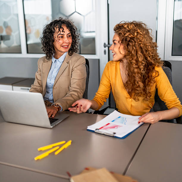 istock Businesswomen collaborating on project in modern office 2246682099