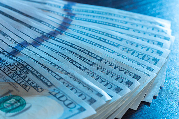 istock Close-up view of neatly arranged hundred dollar bills under soft lighting 2246682557