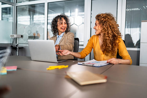istock Women collaborating on laptop discussing business strategy 2246682744