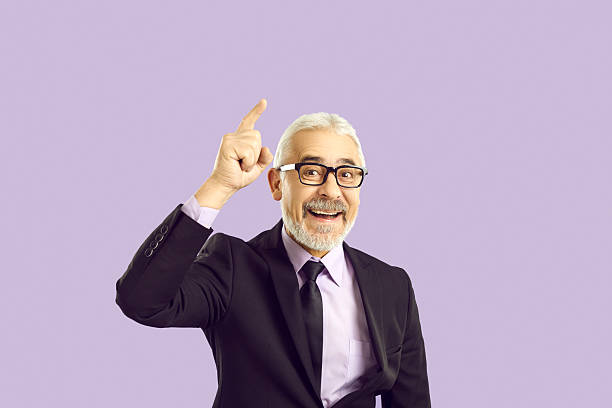 istock Portrait of handsome cheerful gray-haired man showing copy space advert isolated over bright vivid shine vibrant yellow color background 2246683607