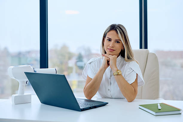 istock Confident doctor smiling at camera in modern office 2246687124