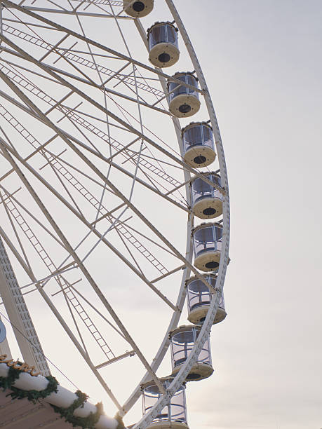 istock Ferris wheel towering against a soft sunset sky by a festive fairground 2246687265
