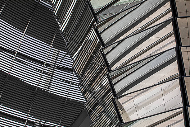 Stylish construction using metal, glass, and mirrored materials in contrasting shapes.