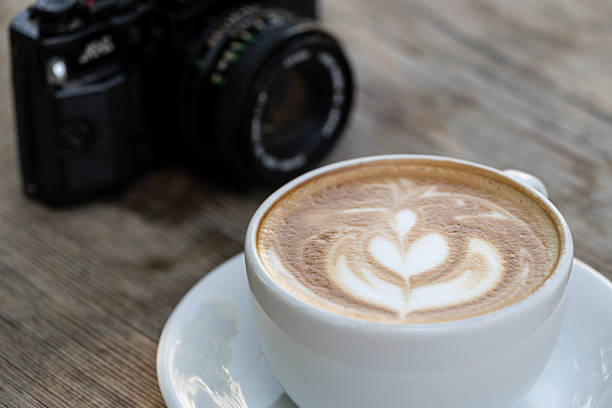 istock Latte coffee and camera on wooden table. 2246689779