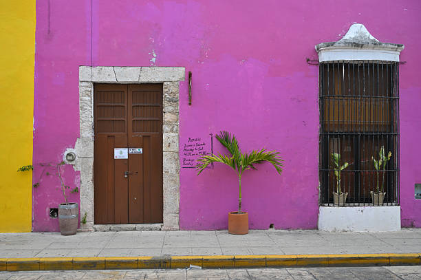 Merida, Mexico - July 20, 2023: Colorful colonial style buildings at street of Merida city old town, Yucatan, Mexico