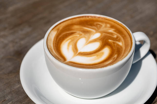 istock Latte coffee on wooden table. 2246690200