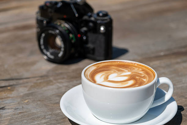 istock Latte coffee and camera on wooden table. 2246691011