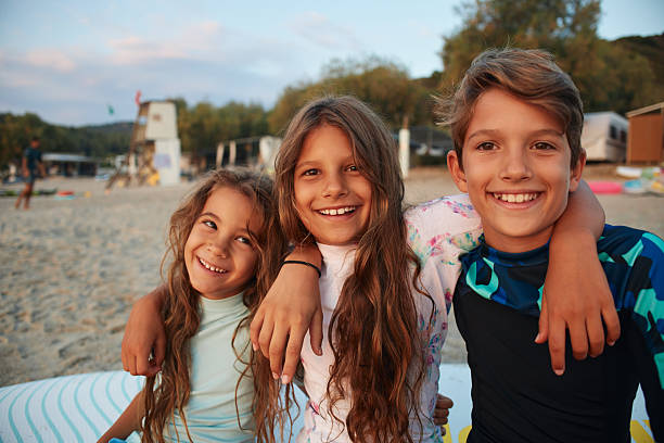 istock Smiling children enjoying summer vacation on beach 2246692382