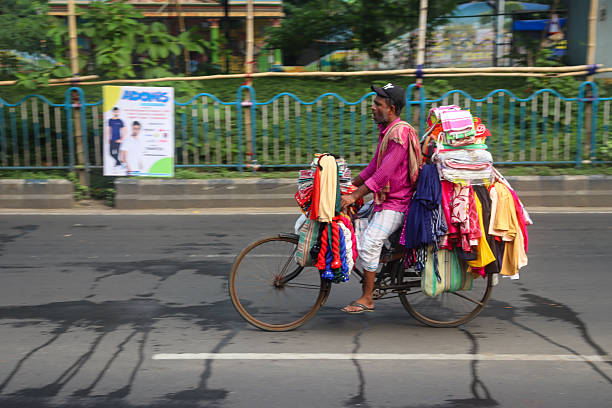 A traditionally dressed man rides a motorcycle through a Kolkata street during the morning rush, captured with a motion blur effect that highlights speed, movement, and the rhythm of city life.Bus at  Kolkata street during the morning rush, captured with a motion blur effect that highlights speed, movement, and the rhythm of city life.