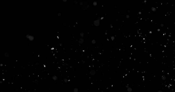 istock Falling snowflakes isolated on black background 2246699568