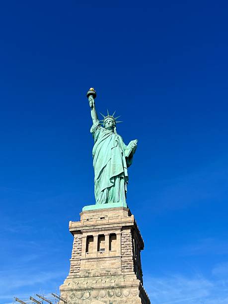 istock Statue of Liberty against a clear blue Sky 2246699974