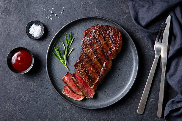 istock Beef Steak medium rare on a black plate. Dark grey background. Close up. Top view. 2246701042