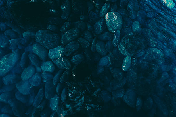 istock dark blue pebbles on the river bottom, top view 2246702076