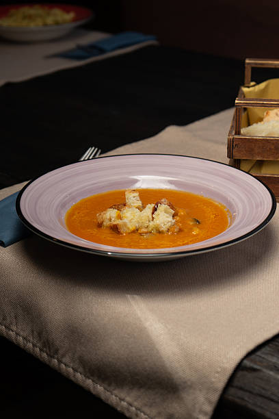 Pumpkin soup and croutons in a bowl at the restaurant