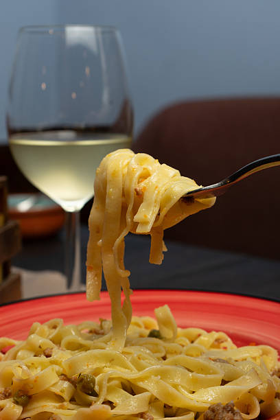 istock Tagliatelle with peas, meat and cheese on a plate at the restaurant 2246702133