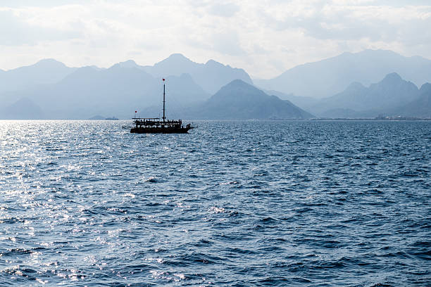 Antalya, Turkey - October 12, 2023. Outdoor scene showing a traditional turkish ship sailing along the caost of antalya.