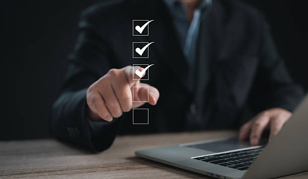 istock Performance checklist concept : businessman using finger with mobile phone for questionnaire, evaluation, assessment online or survey exam and filling out for digital survey and checklist 2246703080