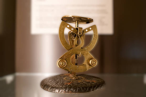 Brass sundial features a detailed design with an adjustable gnomon, resting on a stone base