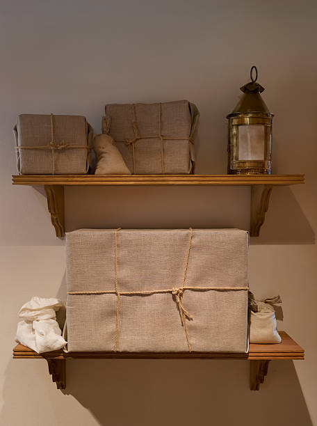 istock Decorative wooden shelves display wrapped packages and lantern in a cozy, minimalistic setting 2246703235