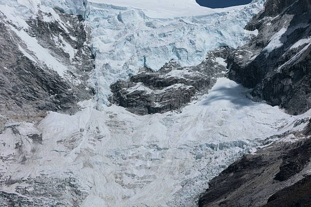 Detailed top-down view of a massive, heavily crevassed glacier. The image captures the complex ice formations and textures of the ice field as it flows.