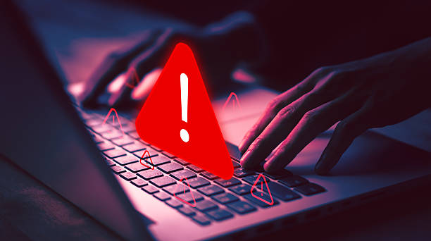 istock Cybersecurity warning with red alert sign on laptop, symbolizing online threat, hacking danger, virus alert, cyber attack, data protection, and digital security issues. 2246706327