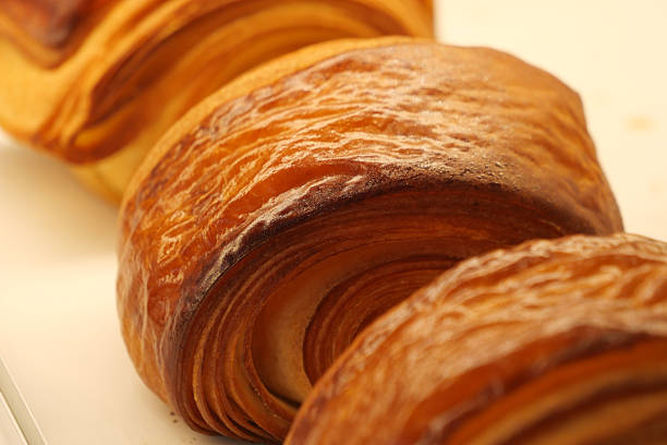 Croissants on display highlighting their flaky layers and golden crust.
