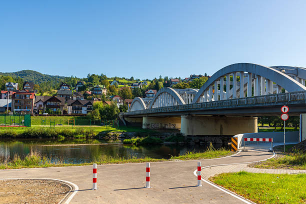 istock Arch bridge over river in small town landscape 2246707444
