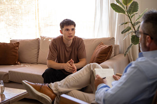 istock Young man in therapy with his psychologist 2246707726