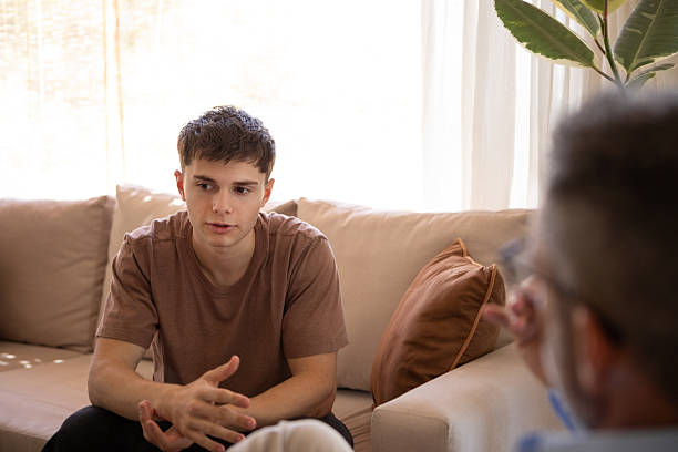 istock Young man in therapy with his psychologist 2246707797