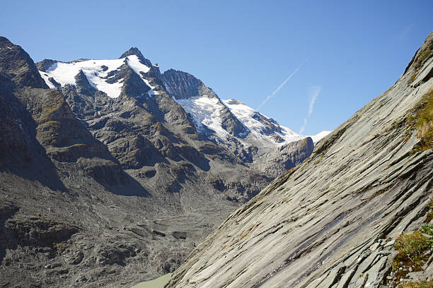 Rock face and snowcapped mountain