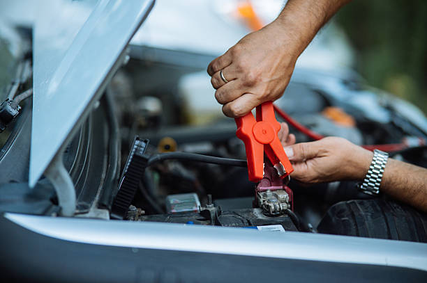 istock Person Jumpstarting a Car with Battery Cables 2246709171