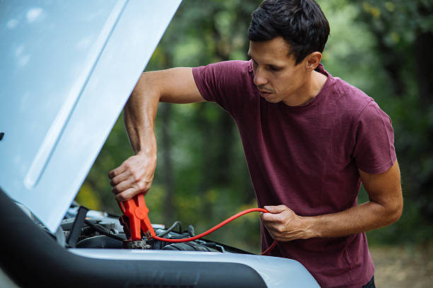 istock Man Jumpstarting a Car in the Outdoors Scene 2246709250