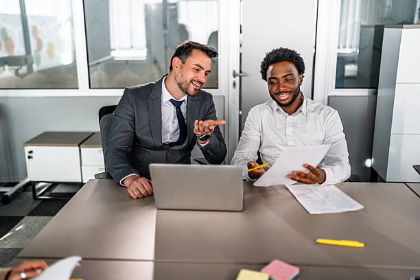 istock Businessmen discussing documents during corporate office meeting 2246709268