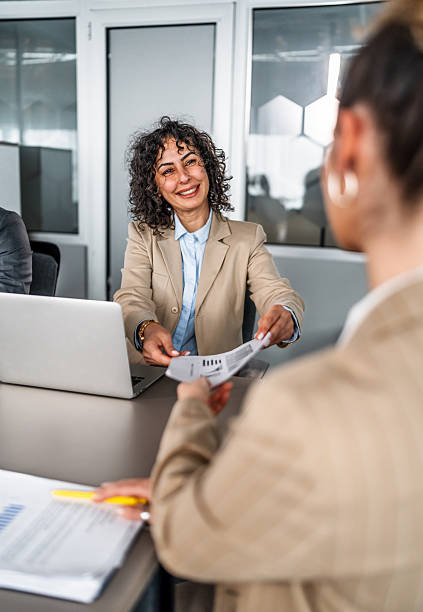 istock Businesswoman passing document in office meeting 2246709555