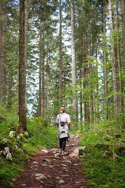 istock Young woman hikes trail in forest 2246710988