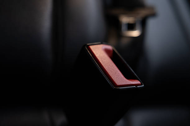 Close up of unrecognizable senior man fastening seat belt in car, copy space