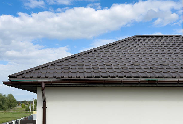 istock Brown metal tile roof with visible downspout and ridge 2246719109